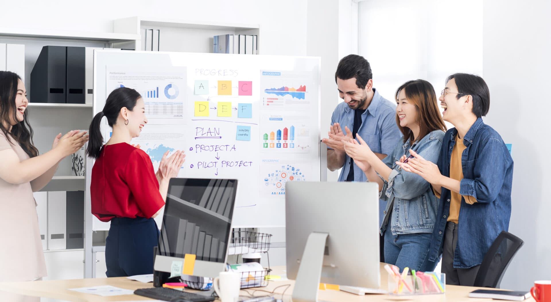 A group of people having a meeting and crapping a hand